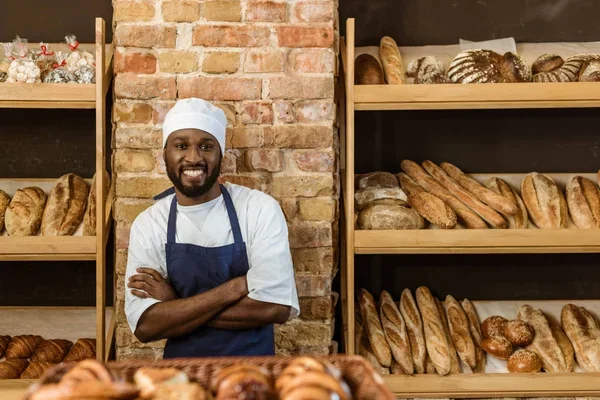 Baker holding a tray of bread