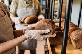 Baker holding fresh bread